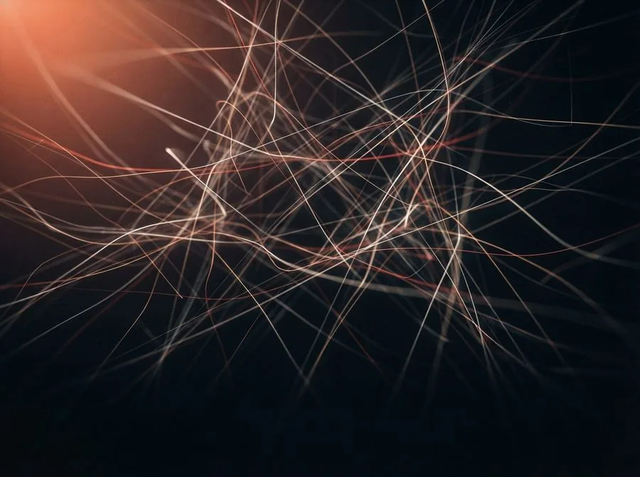 Tangled ember light trails on near black